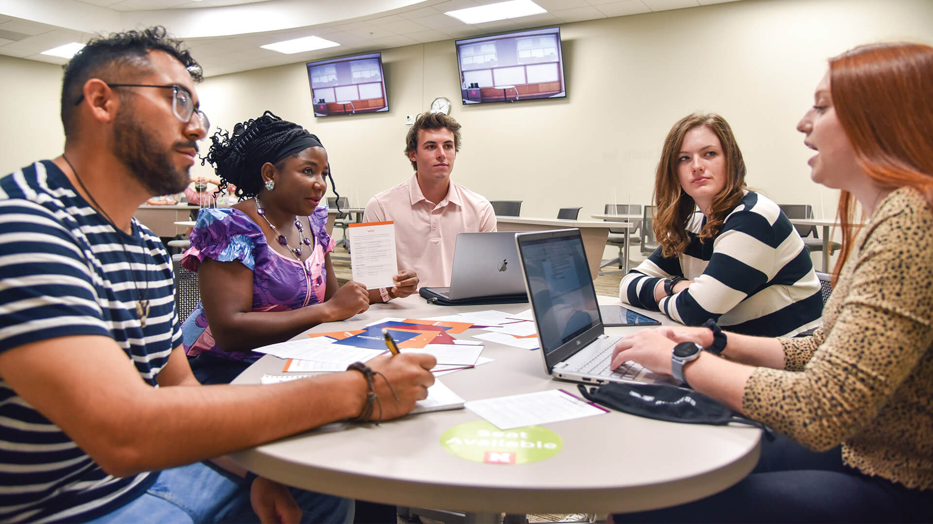 Students sit at roundtable for discussion