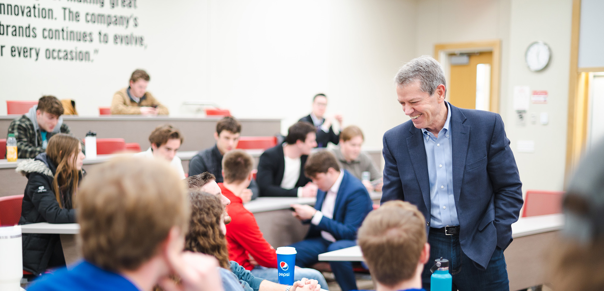 governor jim pillen interacting with students