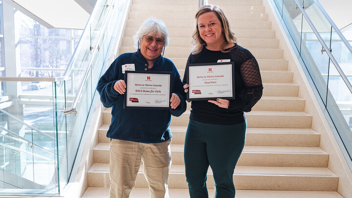 The two recipients holding certificates.