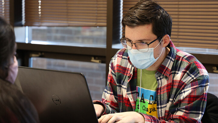 Accounting major Chris Carpenter from Hastings, Nebraska, prepares a community member’s taxes as part of the VITA program.