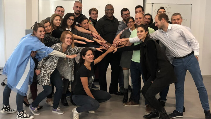 Dr. Jamie Williams, '90, '20, (center) showing unity with his students at Varna Free University in Bulgaria.