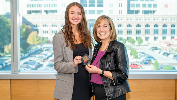 Karly Statter receives a Dean’s Coin from Dean Kathy Farrell for earning the Student of the Month honor in October.