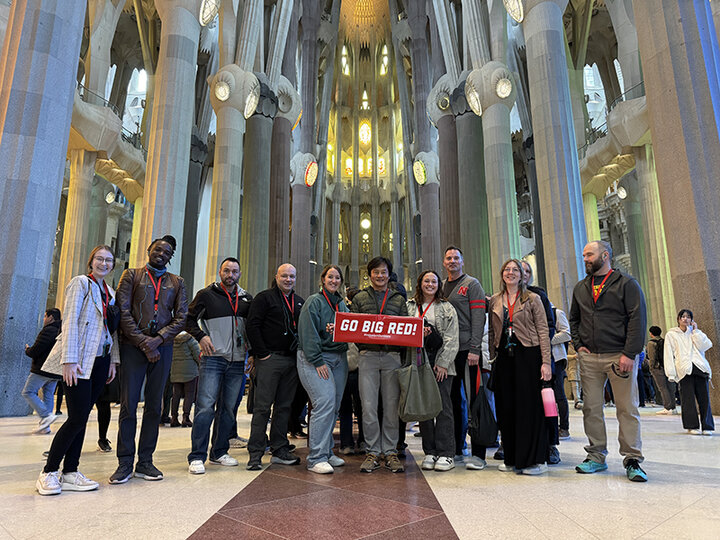 Tony Kang (middle holding Go Big Red sign), Deloitte Haskins and Sells Professor and associate professor of accountancy, led the MBA trip to Spain.