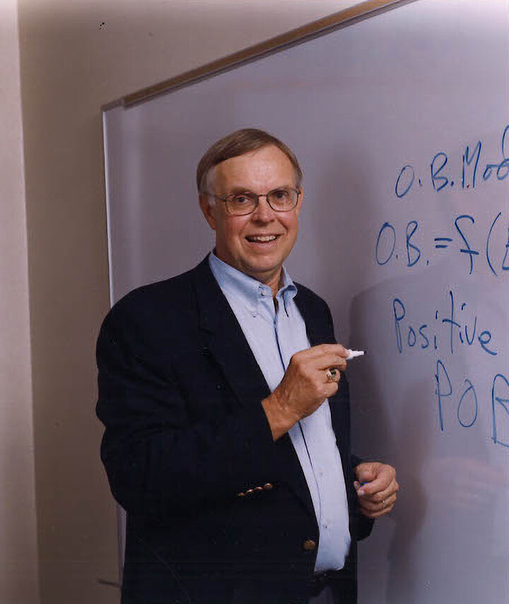 Fred Luthans writing on whiteboard.