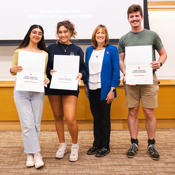 Students standing with the Dean