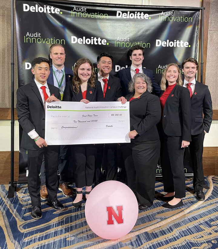 The Nebraska team celebrates the win with advisor Deb Cosgrove and Deloitte staff from their Omaha office, Megan Boyer and Connor Jensen.