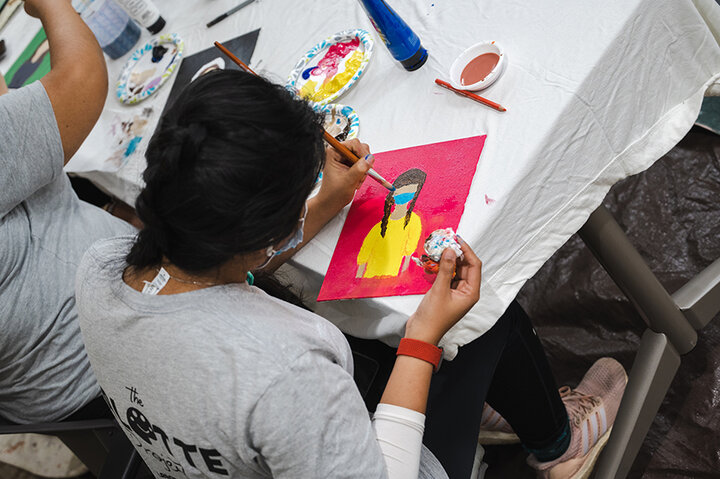 While students waited for their turn at painting the mural, they created self-portraits or portraits of someone they found inspiring on “make and take” canvases.