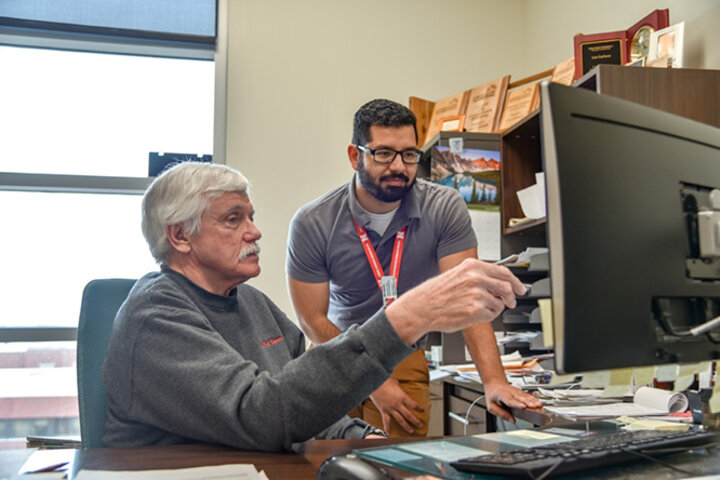 Les Carlson works with Nery Cabrera, computer support assistant