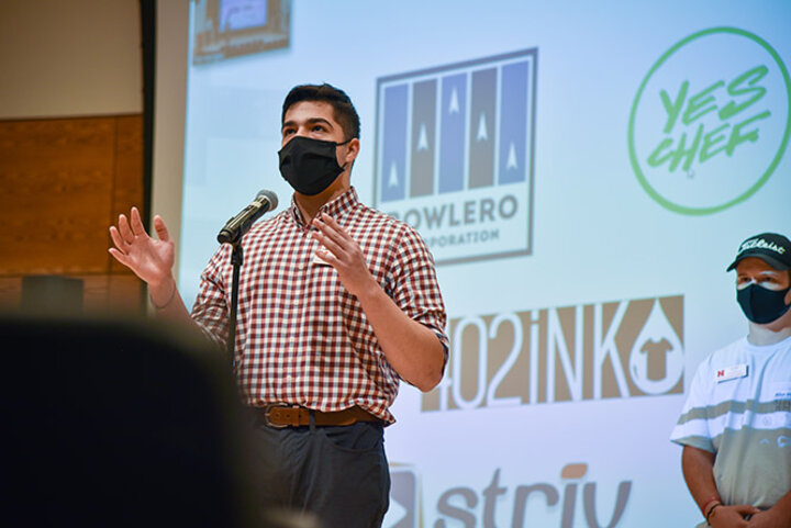 Eduardo Mora, sophomore management major from Madison, Nebraska, answers questions about his team’s community consulting project.