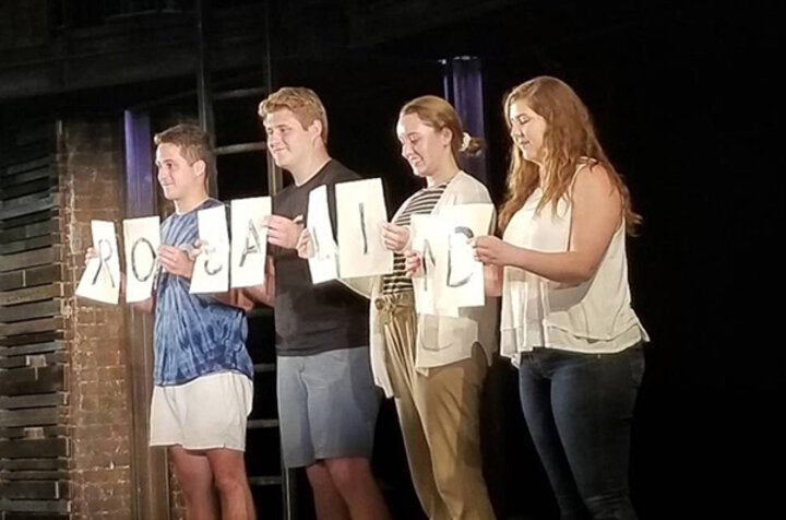 Four Nebraska students on stage during the performance of “As You Like It."