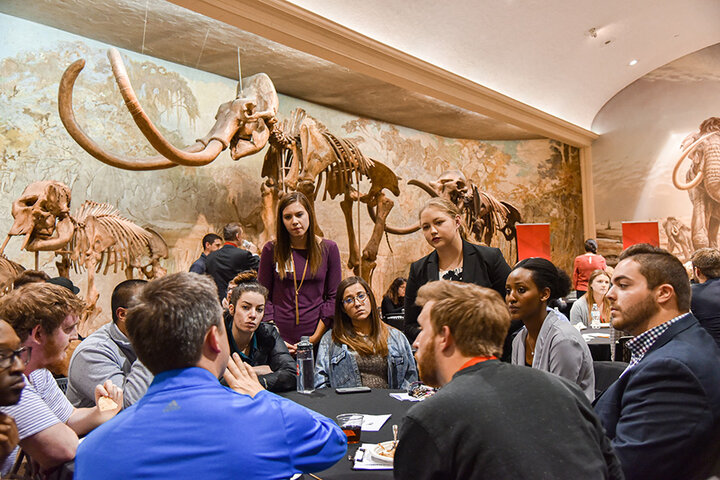Uwanjye (right) and other competitors hear feedback from their room's judges.