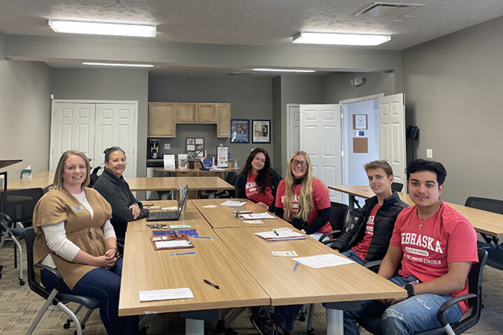 Students (left to right) Lexi Westover, Lindsay Rickers, Ian Harper and Jorge Hidalgo visited with Kate Holman, development director, and Anna Lyman, homeownership director, of NeighborWorks Lincoln