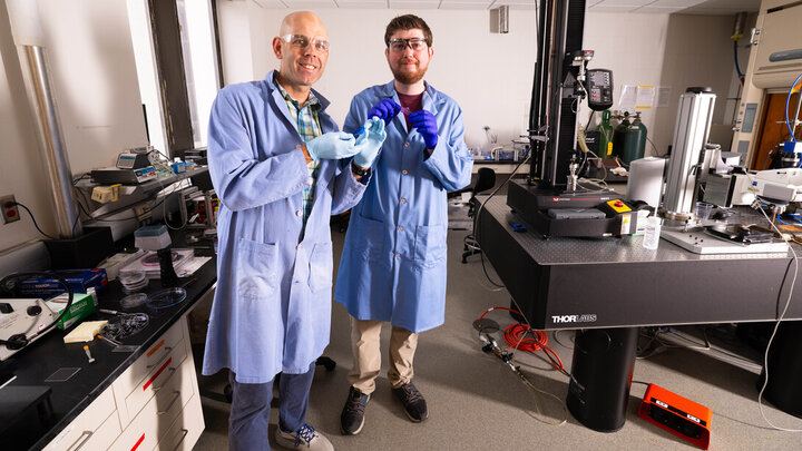 Steve Morin and Brennan Watts holding two colorful hydrogel skins.