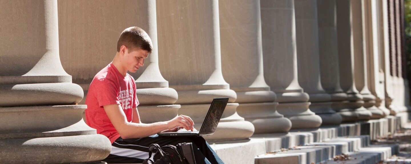 Student outside with a computer