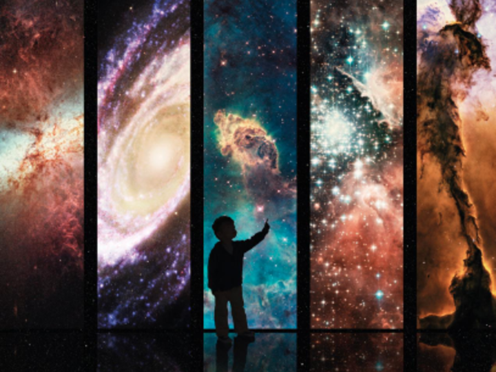 Silhouette of a child pointing in front of five panels depicting different, colorful nebulae