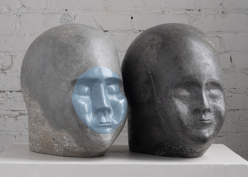 Concrete heads on white counter.