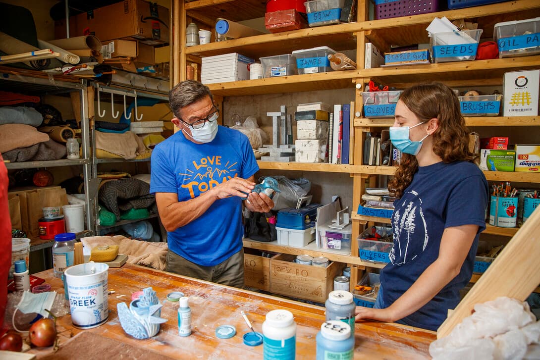 Kinga Aletto, a pre-veterinary medicine and fisheries and wildlife major, works with Eddie Dominguez, professor of art, on a life-size clay model of the endangered Javan blue-banded kingfisher for her summer UCARE project.