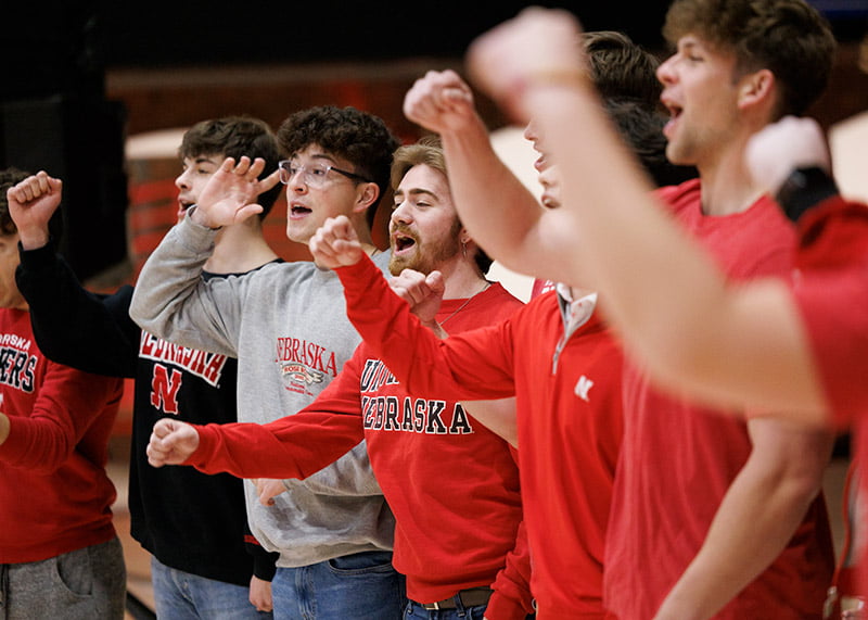 Men chant while pumping their fists.