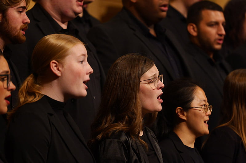 Singers perform on stage.