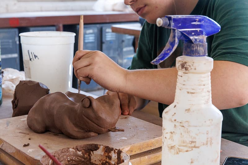 The beginnings of an animal shape made of clay.