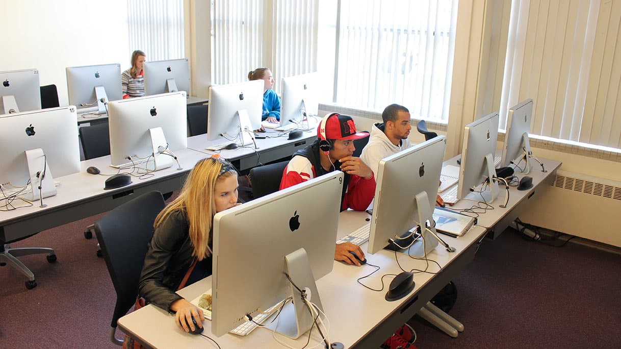 Students work at computers.