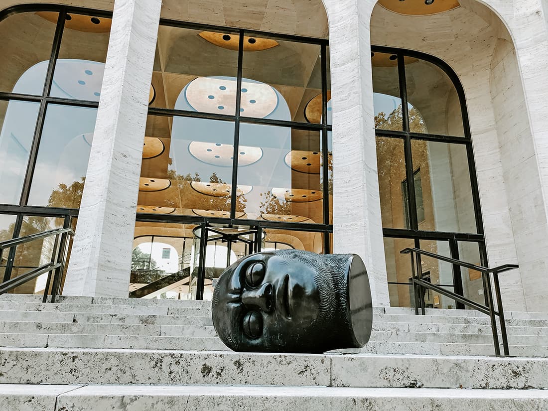 A large clay head on the steps outside the front of Sheldon Museum of Art.