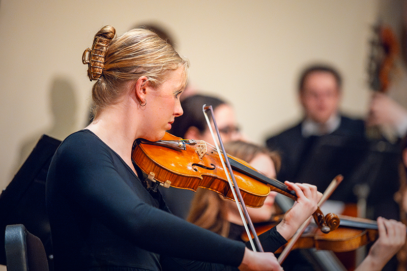 A woman plays violin.