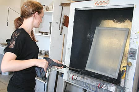 A student pressure sprays a screen.