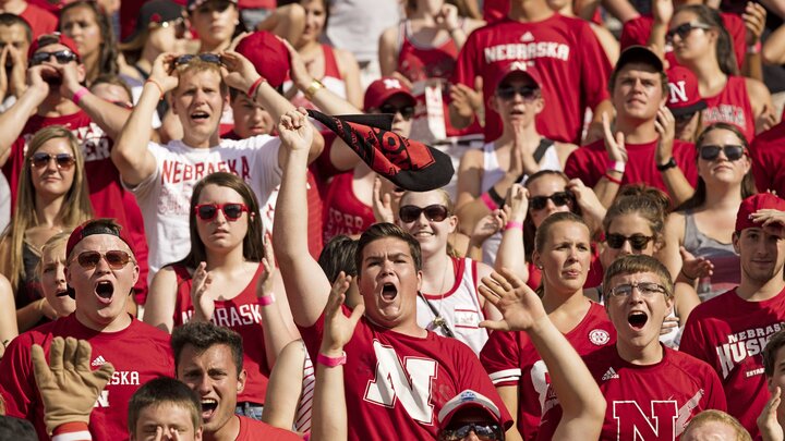 Students cheering at a Nebraska football game