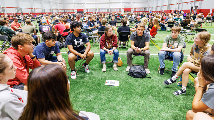 Students sit in roundtable discussions in Husker Pavilliion