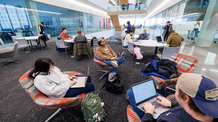 Students sitting with laptop in study room of Kiewit Hall