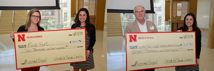 Keeana Moore, a senior economics and management major from Grand Island, Nebraska, presents awards to Michaela Akridge of Food Fort and Max Graves of the Center for Legalized Immigration Assistance.