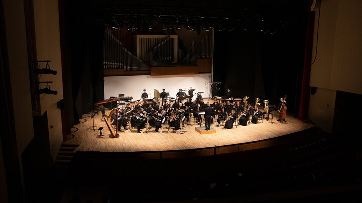 File photo of the Symphonic Band on stage in Kimball Recital Hall with Tony Falcone conducting. 