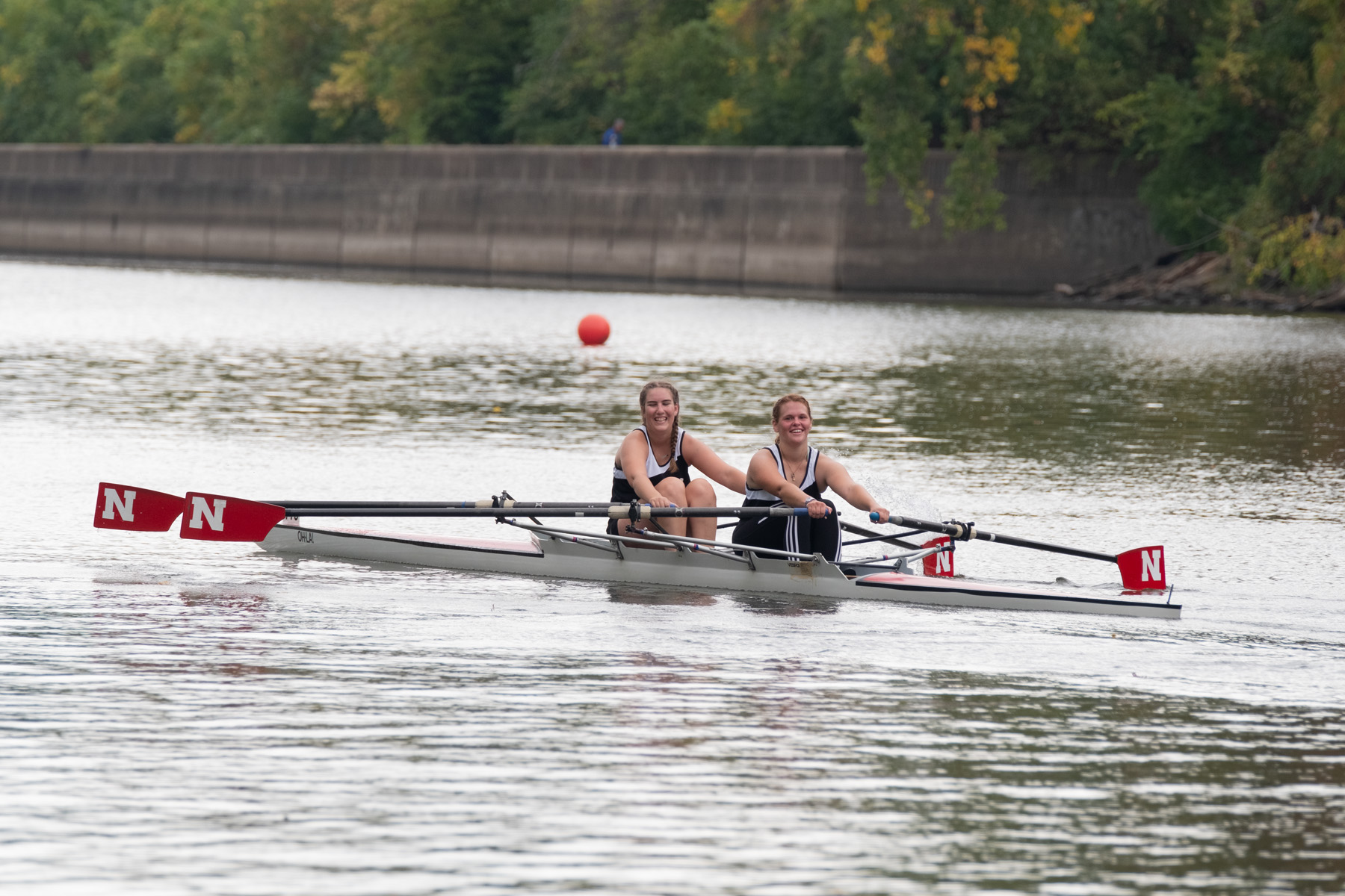 Women's Pair rowing with Nebraska marked oars