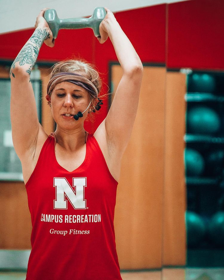 A young woman teaching a fitness class