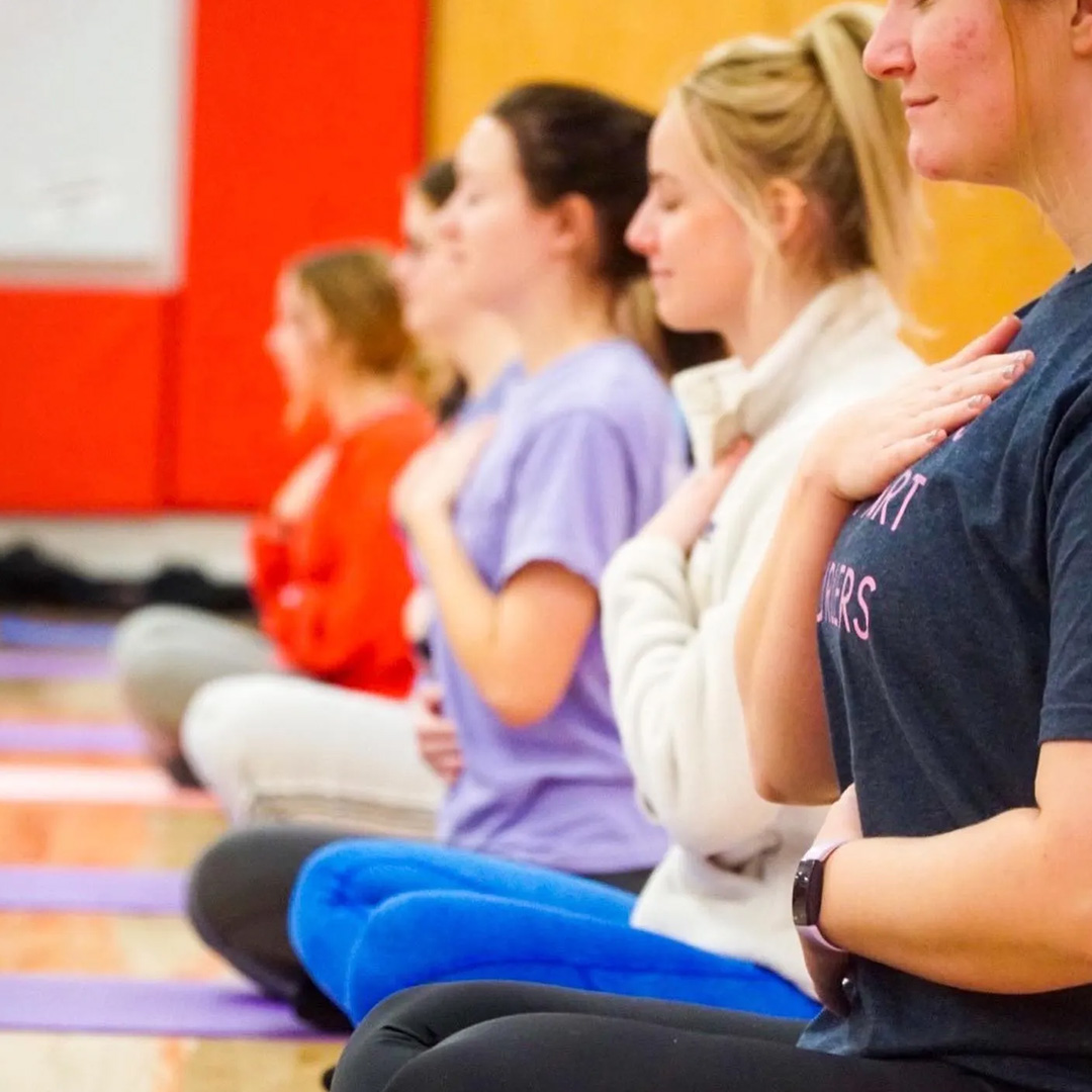 Students participating in a yoga class