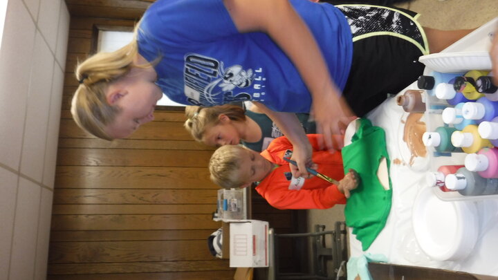 Youth volunteer helping at clover kid camp