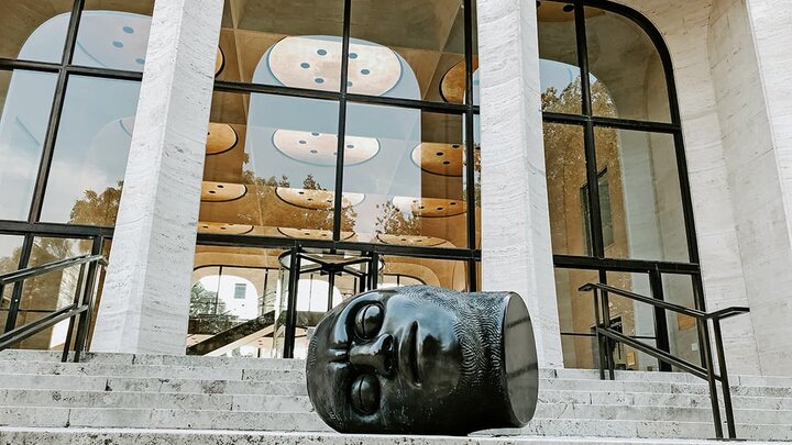 A large clay head outside the front of Sheldon Gallery.