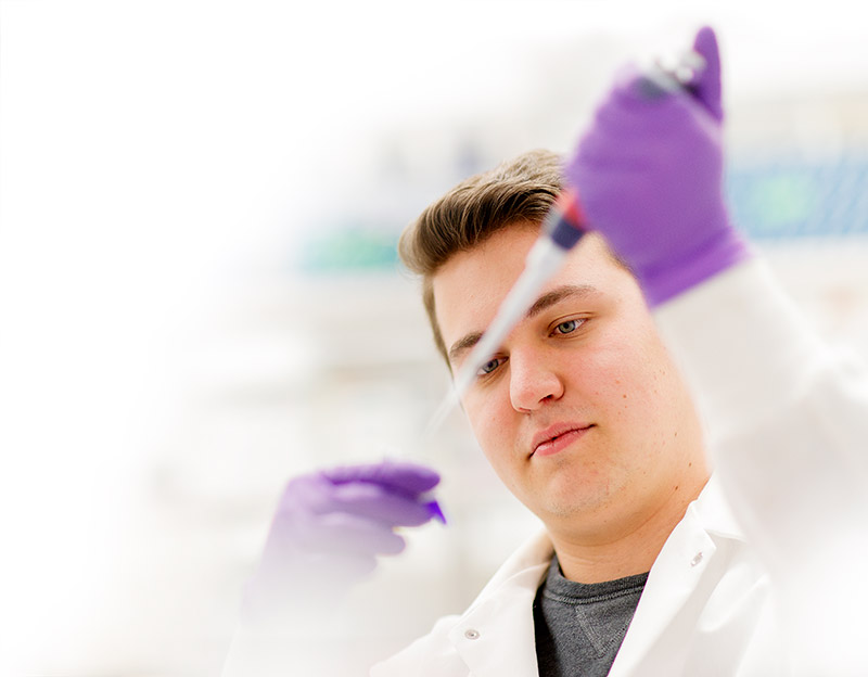 Student in lab coat.