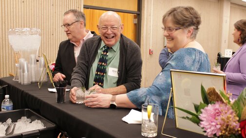 Attendees getting mocktails from the bar