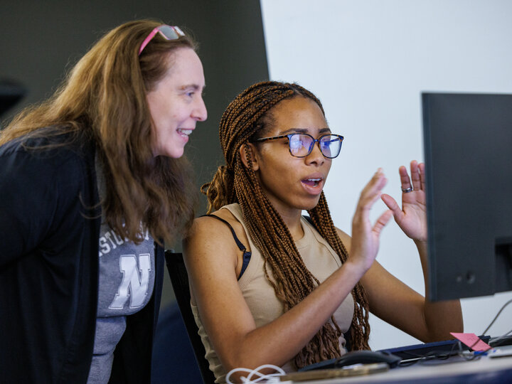Photo of Libraries staff assisting student on a computer
